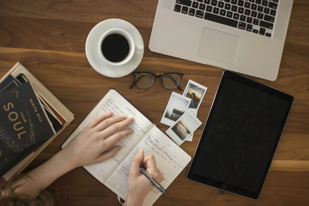 Person writing in a notebook. Contextual image.