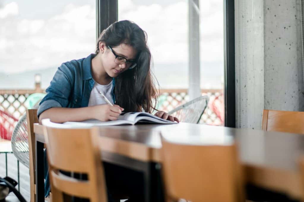 Student studying and writing. Contextual image for Bayside scholarship story.