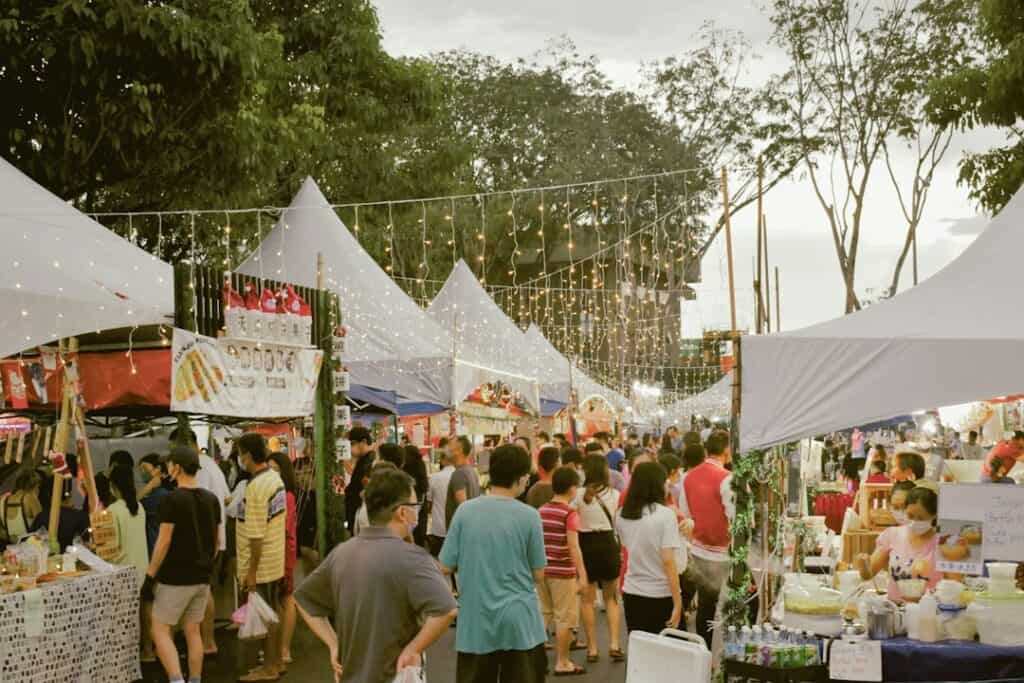 People browsing an outdoor community market. Contextual image.